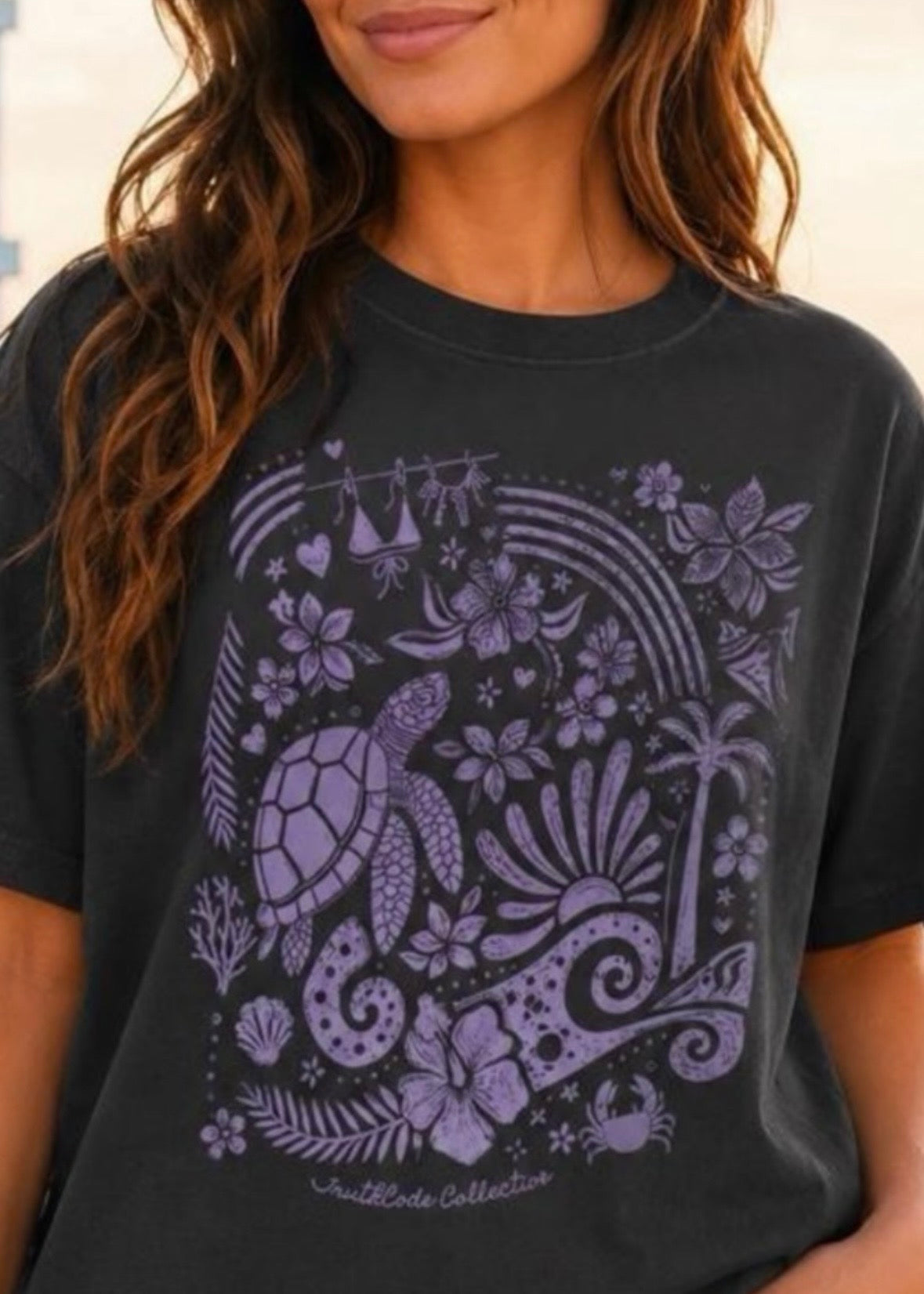 Person wearing a black t-shirt with a purple turtle design and text.