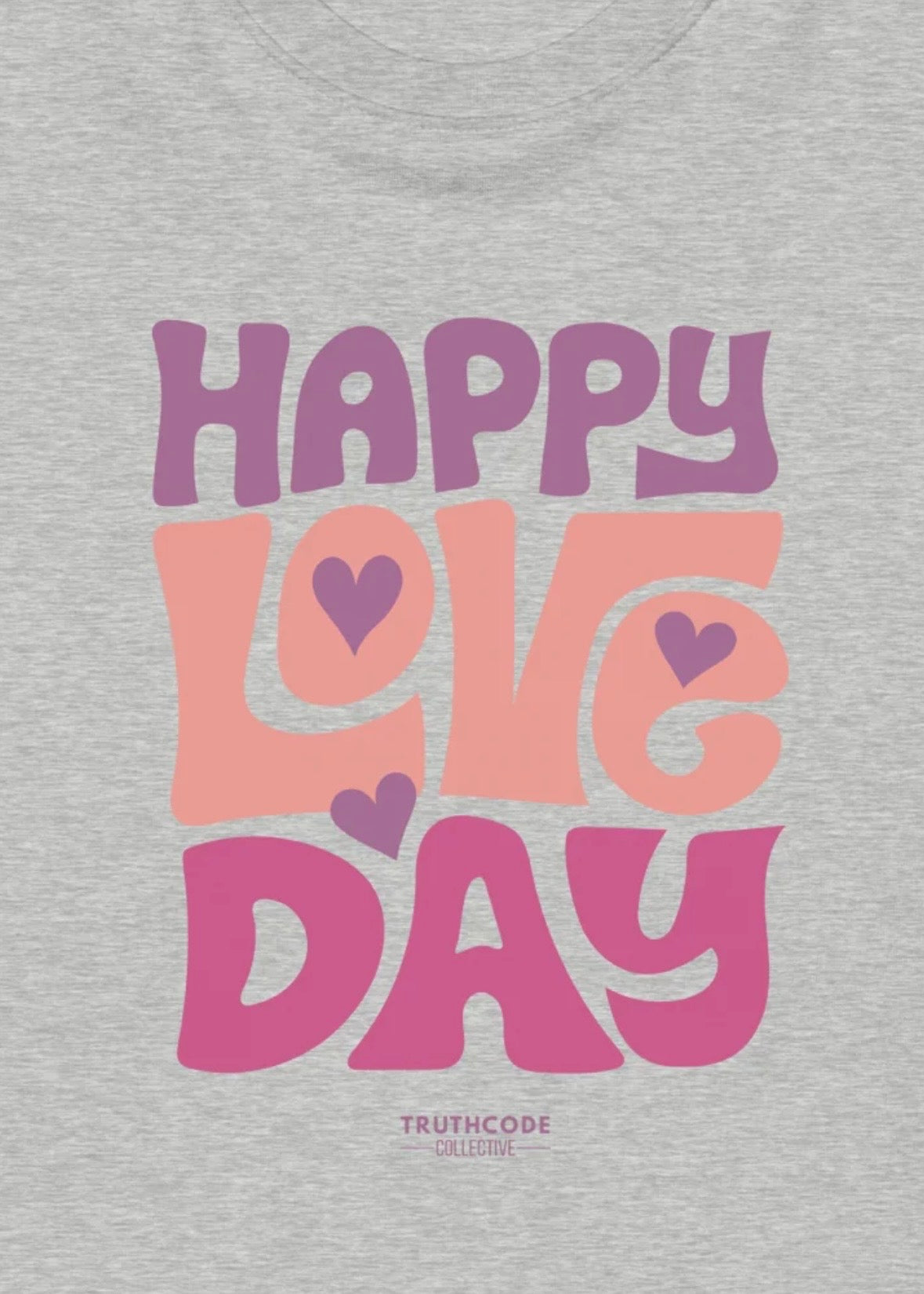 Close view of gray t-shirt with 'Happy Love Day' text design in purple, pink, and orange 