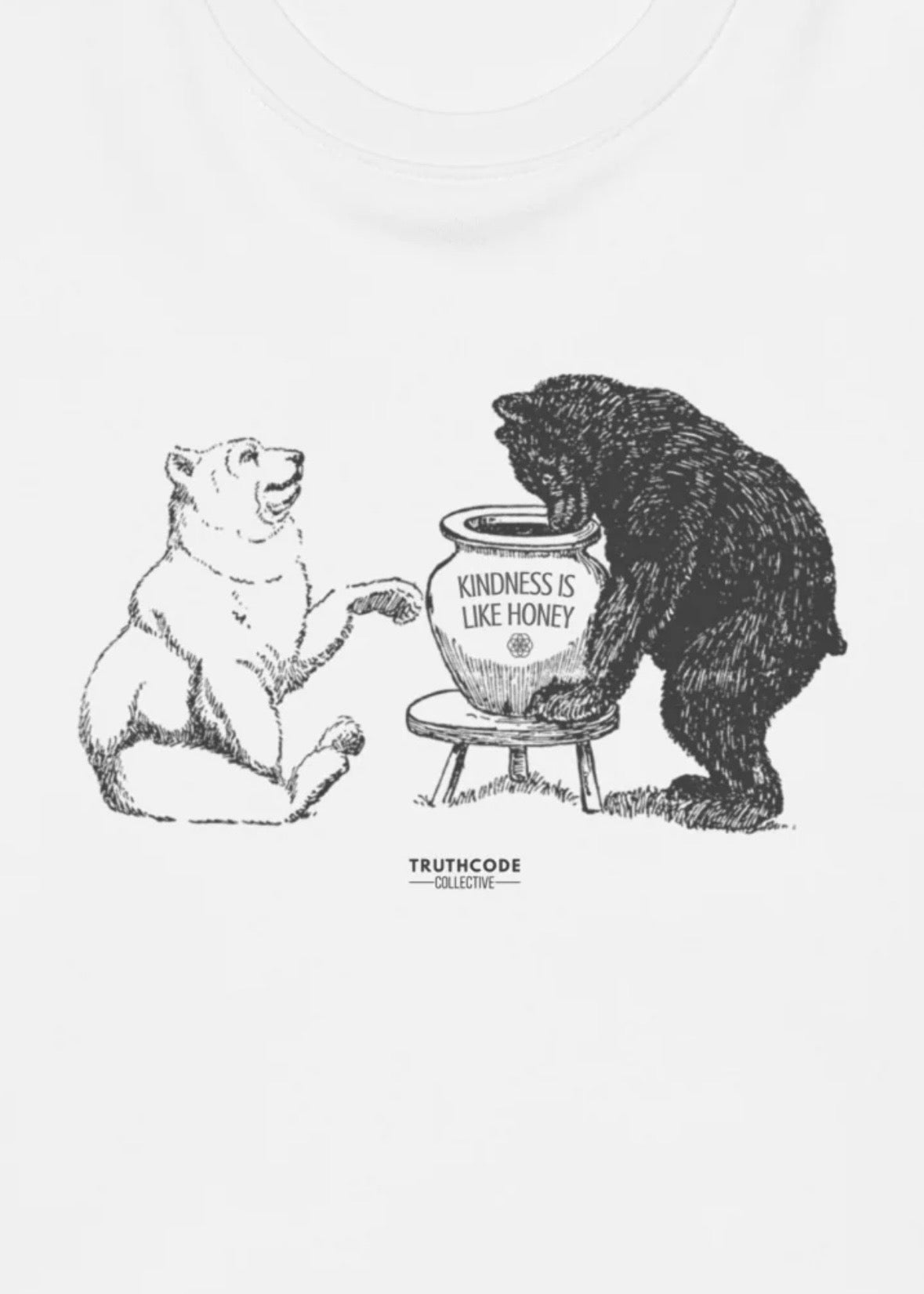 Close view of white sweatshirt illustration of two bears with a pot labeled 'Kindness is like honey' 