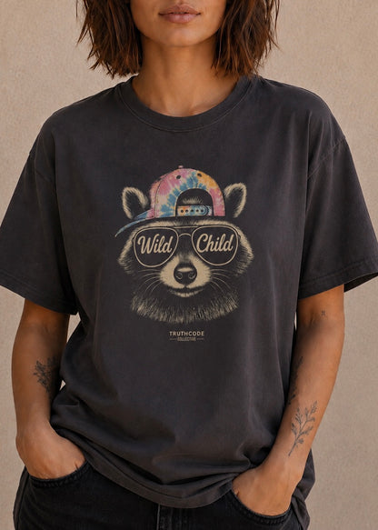 Person wearing a black t-shirt with a raccoon graphic and 'Wild Child' text on a beige background