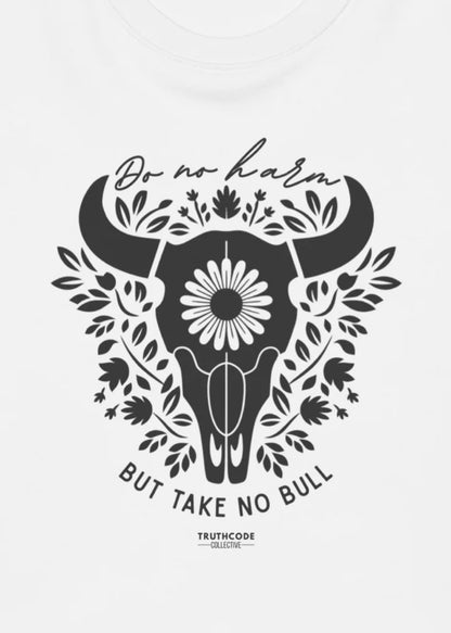 Close view of white t-shirt with black bull skull design with floral elements and text 'Do no harm, but take no bull' 