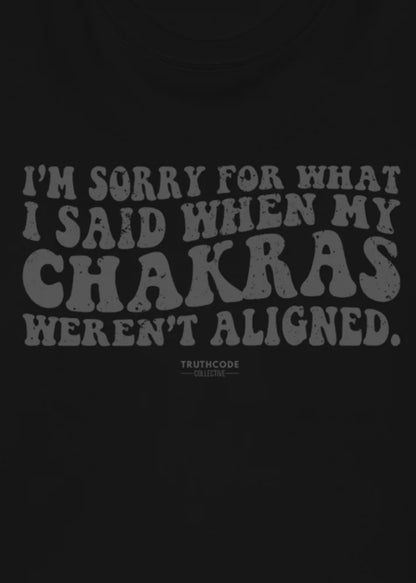 Close view of black t-shirt with text design 'I'm sorry for what I said when my chakras weren't aligned' 