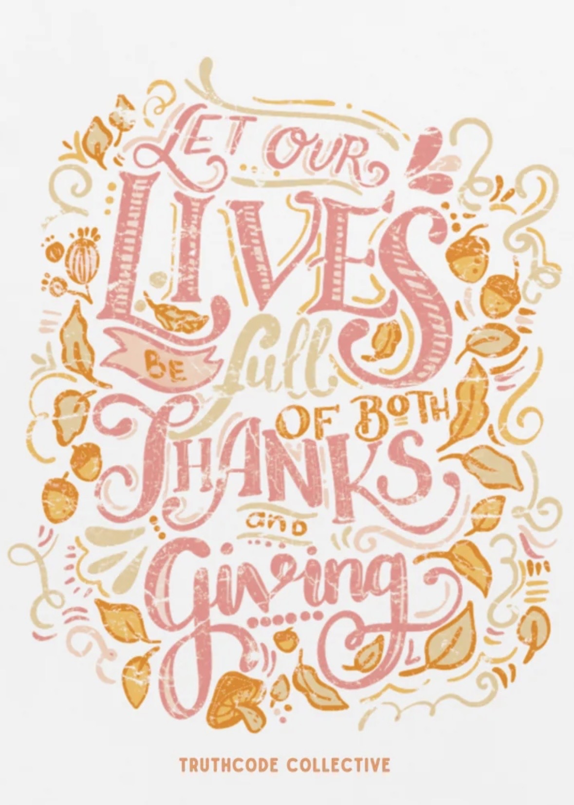Close view of white t-shirt with decorative text 'Let our lives be full of both thanks and giving' surrounded by autumn elements 