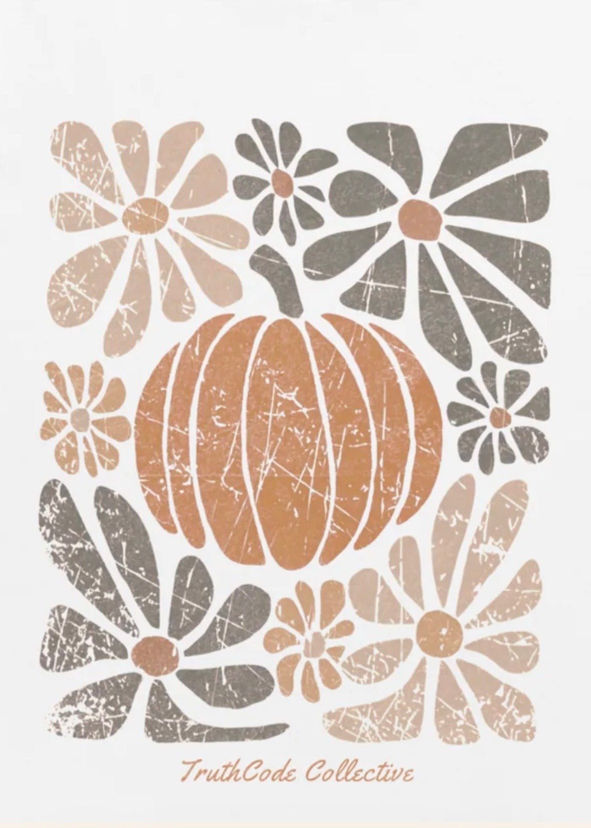 Close view of white t-shirt with decorative design with a pumpkin and stylized flowers 