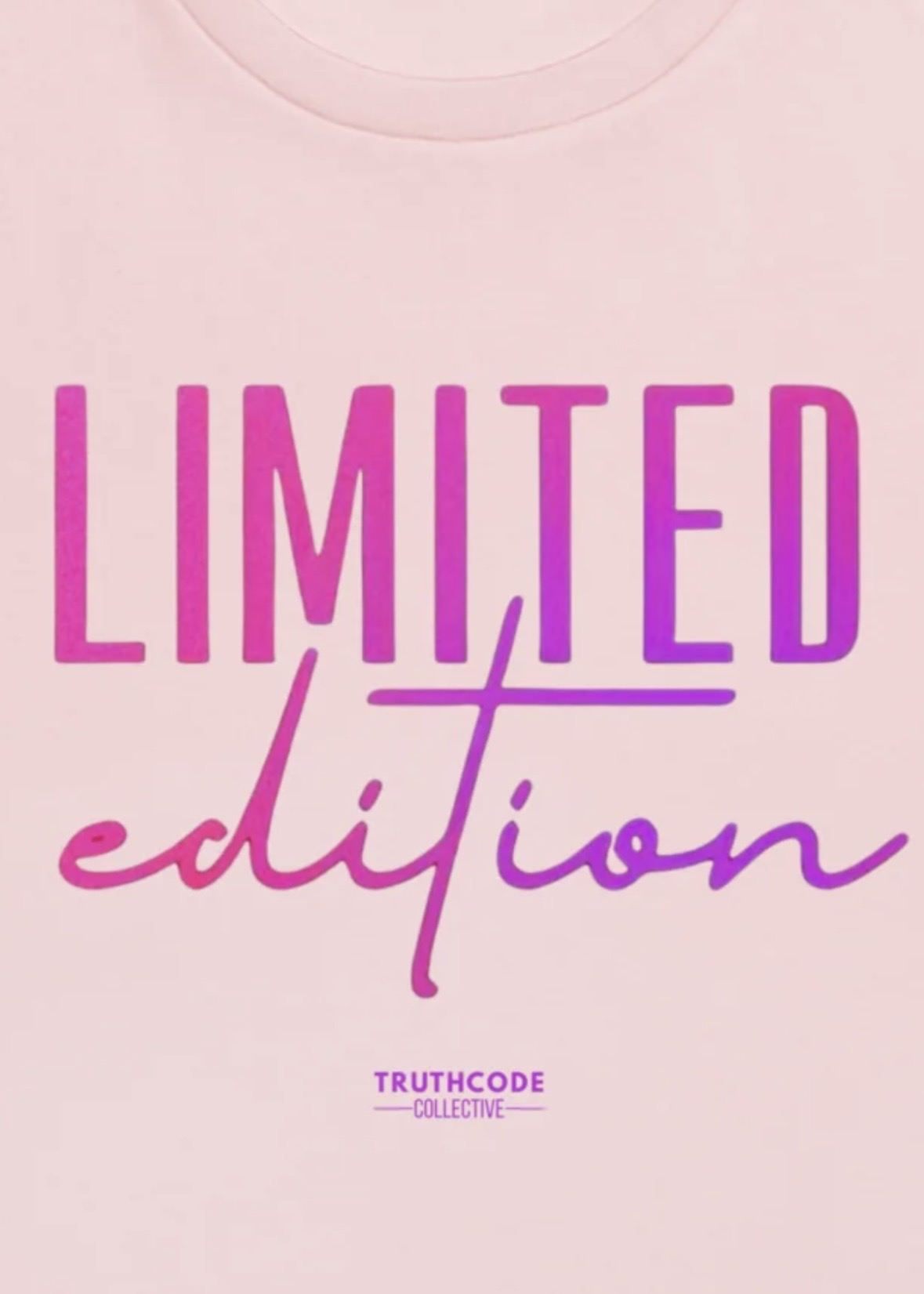 Close view of pink organic t-shirt with 'LIMITED edition' text design, on a white background