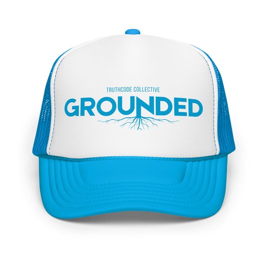Blue and white cap with 'GROUNDED' text and tree root graphic on a white background