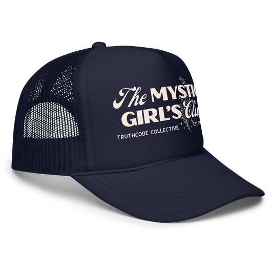 Side view of navy blue trucker hat with mesh and 'The Mystic Girl's Club' text, on a white background