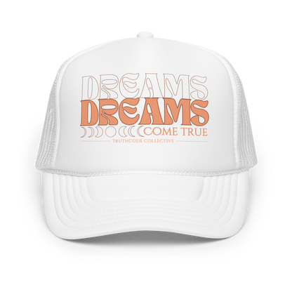 White trucker cap with 'Dreams Come True' text on a white background