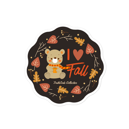 Sticker with a bear wearing an orange scarf and 'I love fall' text on a black background.