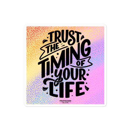 Square sticker with colorful gradient background with motivational quote 'Trust the timing of your life' and brand name 'Truthcode Collective'.