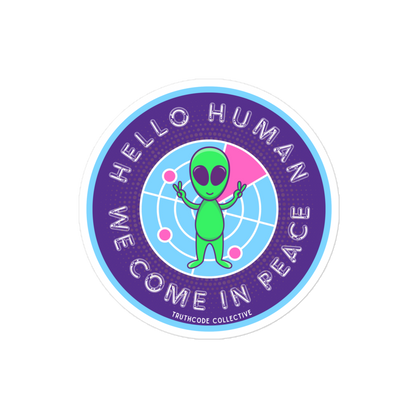 Circular sticker with green alien and text 'Hello Human, We Come in Peace' on a white background