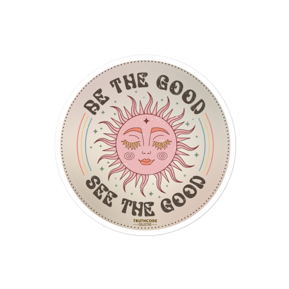 Circular sticker with sun design and text 'Be the good, see the good' on a beige background