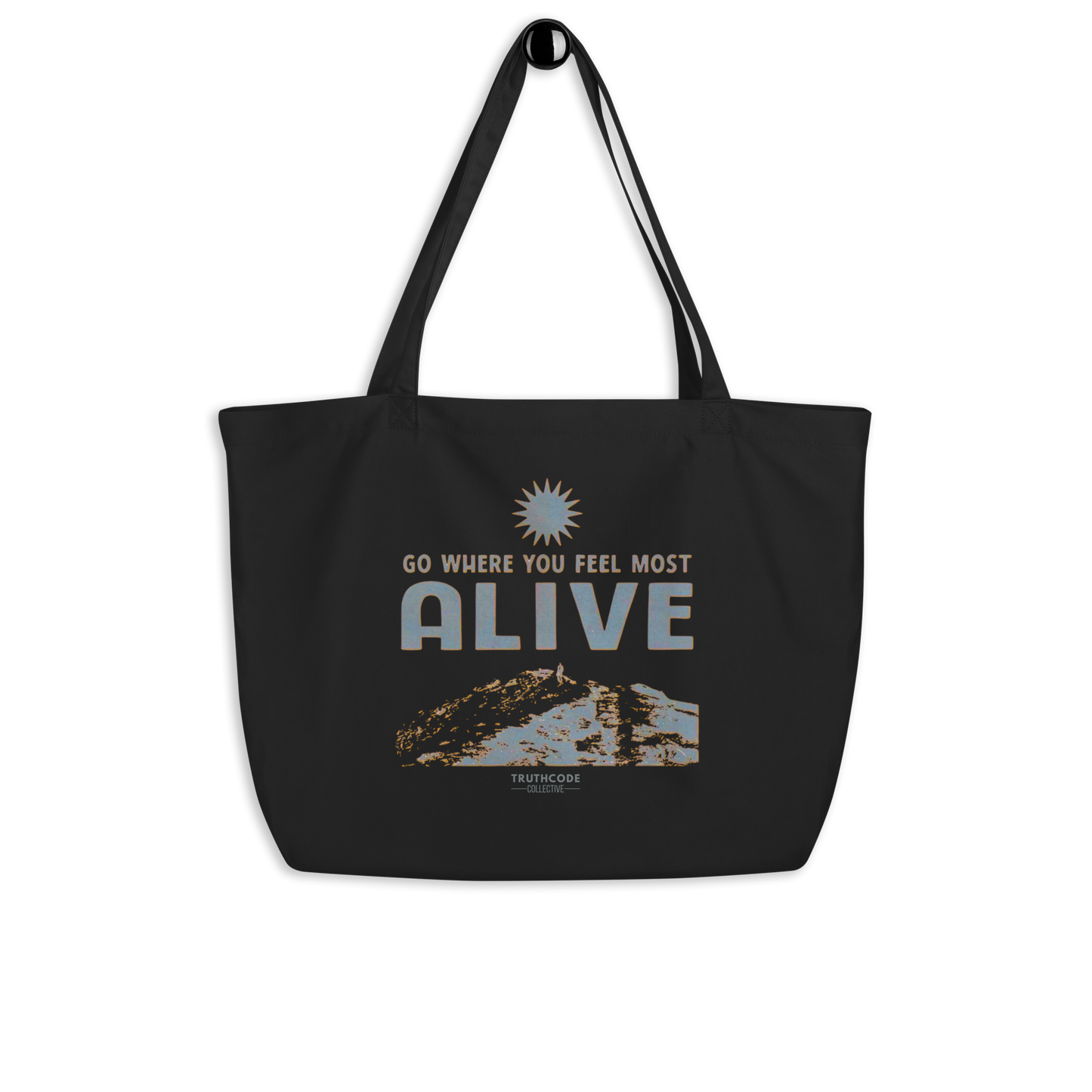 Black organic tote bag with motivational quote 'Go where you feel most alive' and nature graphic on a white background