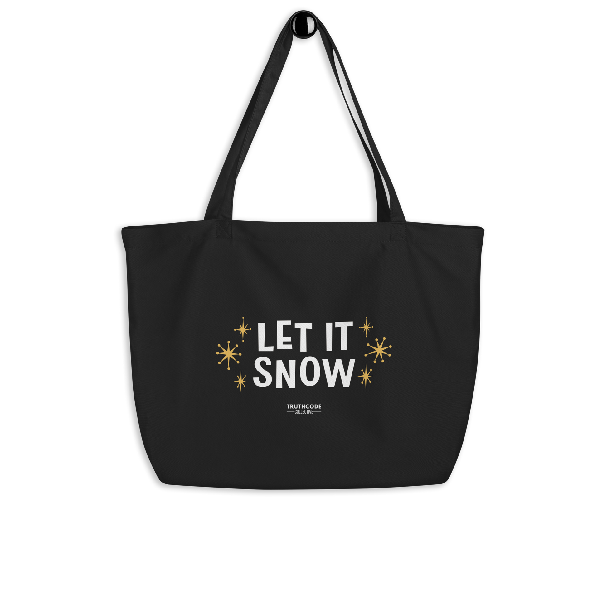 Black organic tote bag with 'Let It Snow' text and star designs on a white background