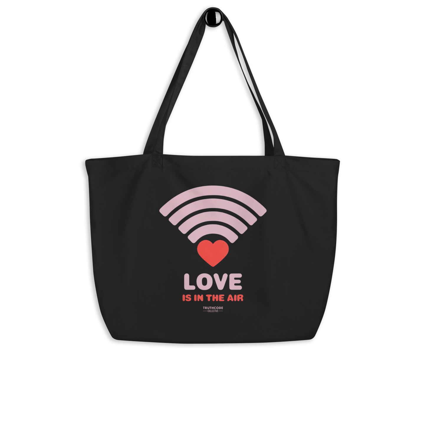 Black organic tote bag with pink heart wifi graphic design and text 'LOVE IS IN THE AIR' on a white background