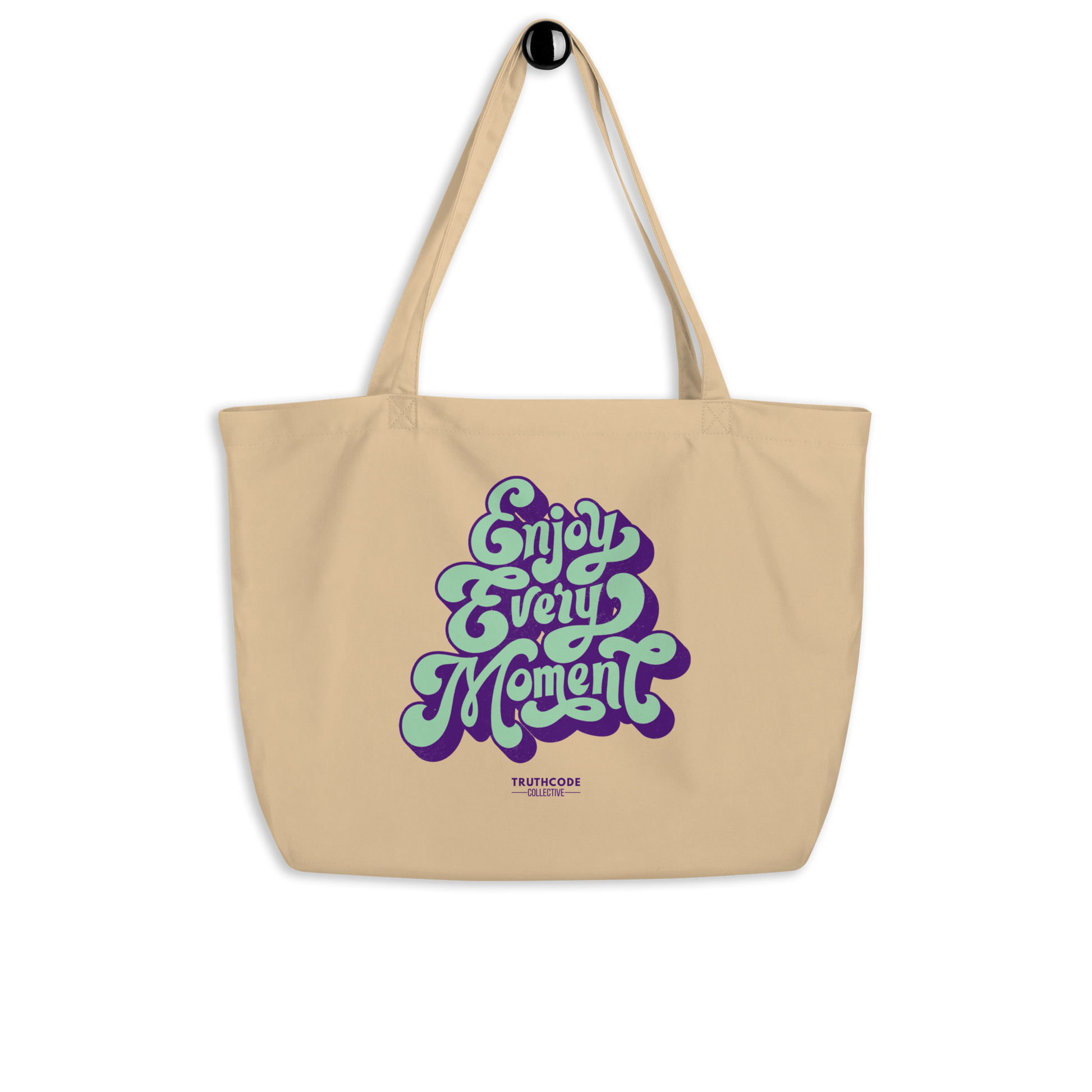 Beige organic tote bag with 'Enjoy Every Moment' text design on a white background