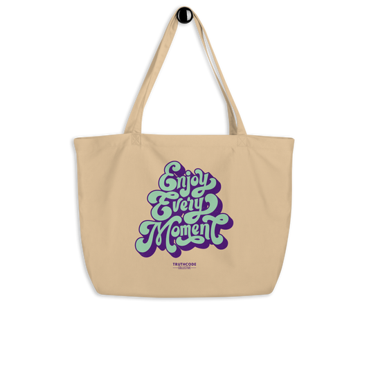 Beige organic tote bag with 'Enjoy Every Moment' text design on a white background