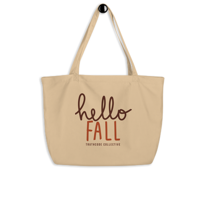 Beige organic tote bag with 'hello FALL' text and Truthcode Collective logo on a white background