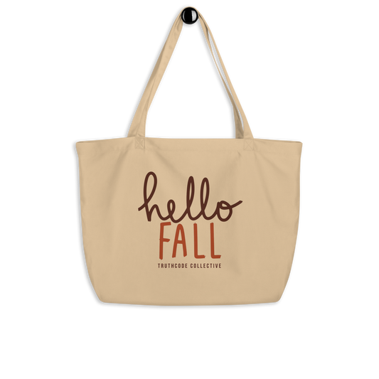 Beige organic tote bag with 'hello FALL' text and Truthcode Collective logo on a white background