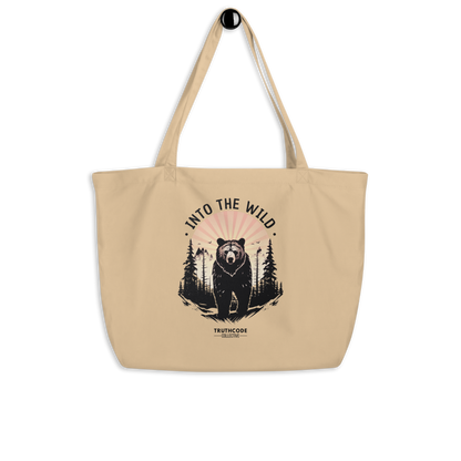 Beige organic tote bag with bear graphic and 'Into the Wild' text on a white background