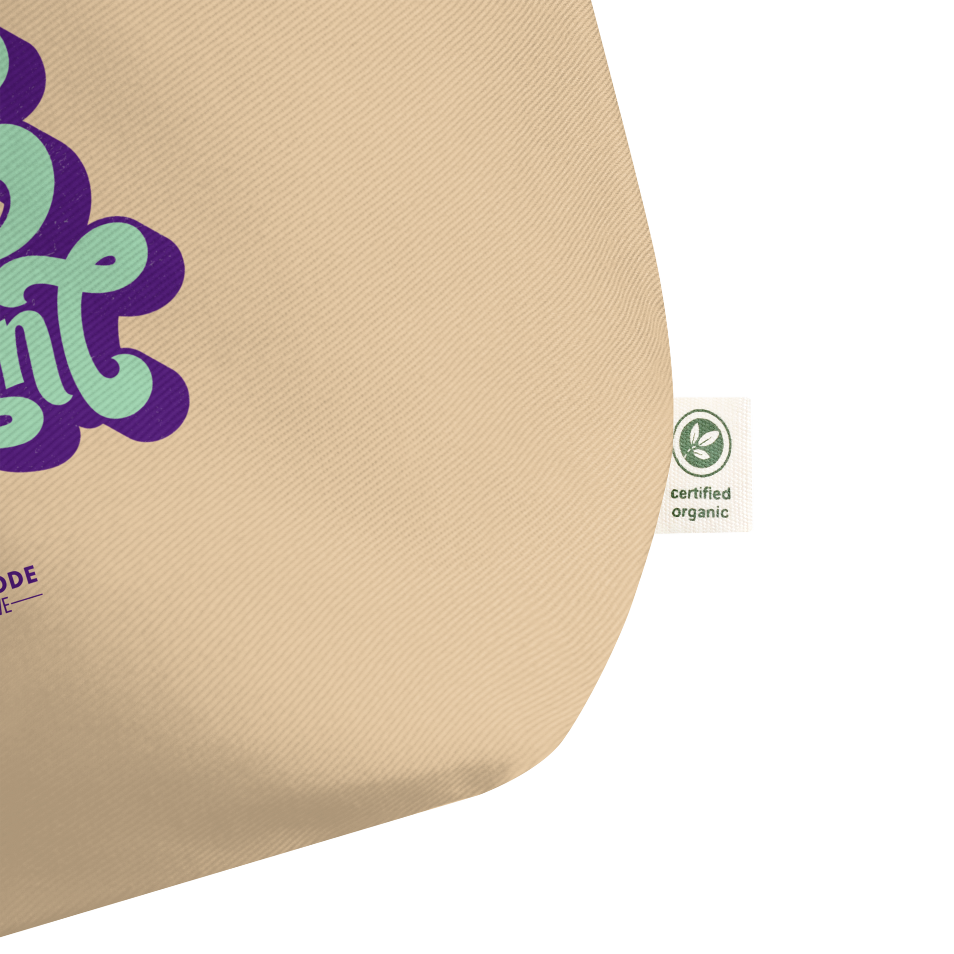 Beige tote zoomed in on green and white certified organic label on a white background