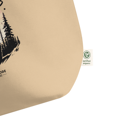 Corner of beige tote bag showing certified organic label on a white background