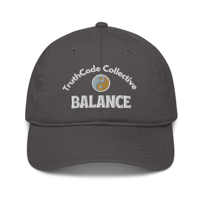 Dark gray cap with 'TruthCode Collective' and 'Balance' text with yin yang design, on a white background