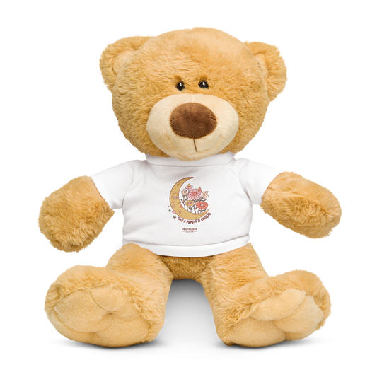 Plush teddy bear wearing a white t-shirt with a moon and floral design 