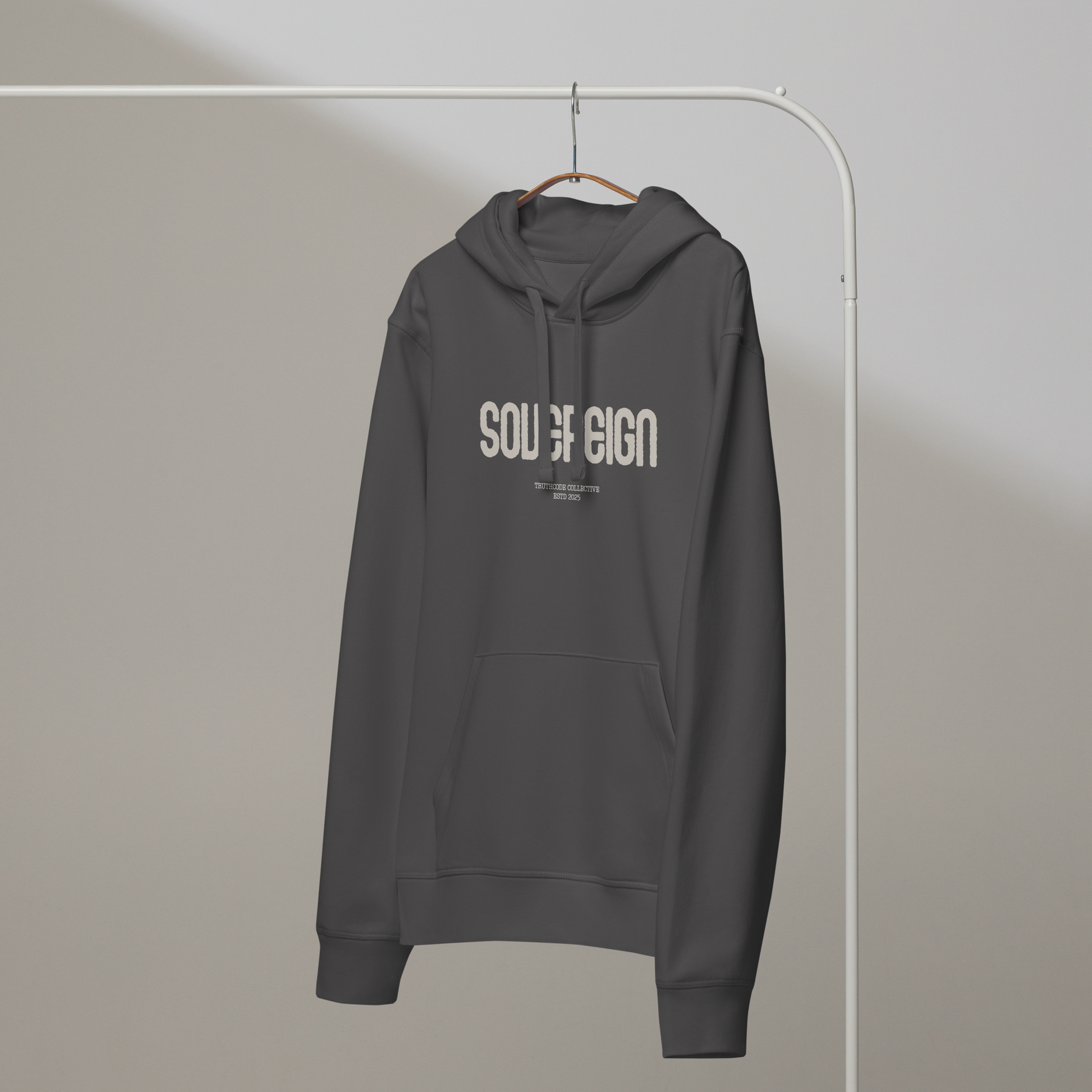 Gray organic hoodie with 'Sovereign' text on a white hanger with a gray wall background