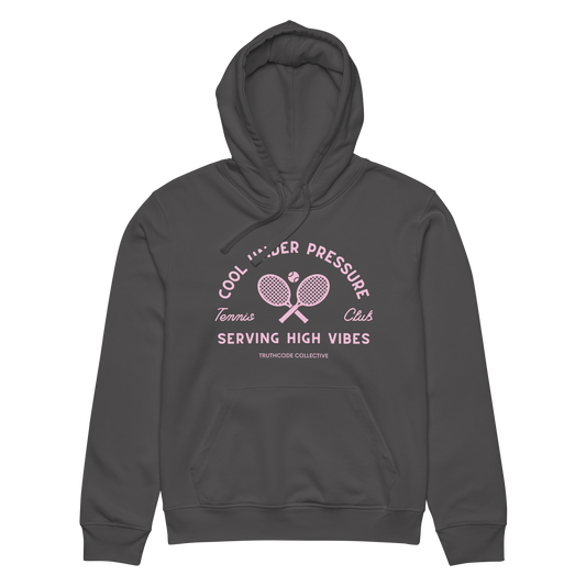 Dark gray organic hoodie with pink and white text 'Cool under pressure, serving high vibes' and tennis graphics on a white background