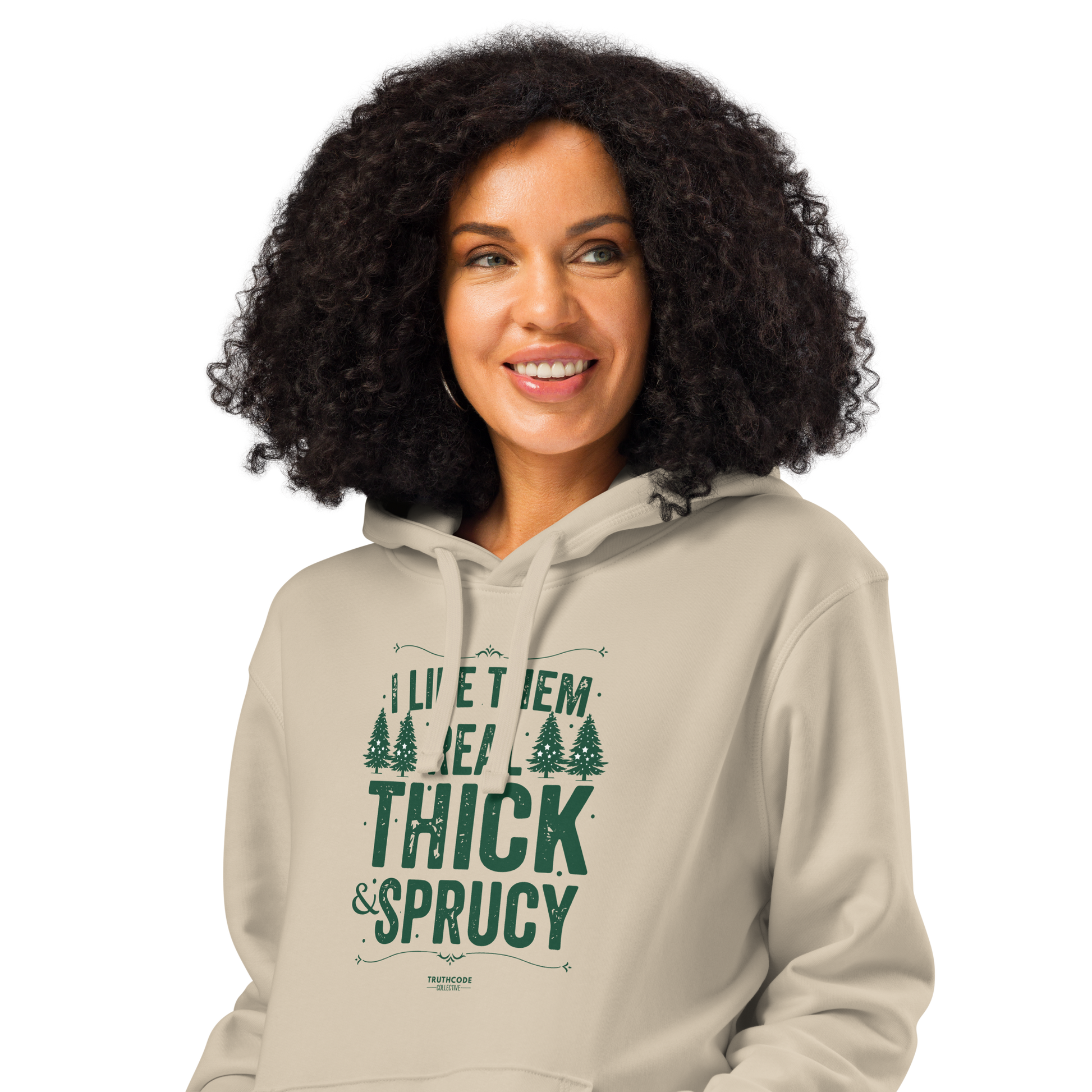 Woman wearing beige organic hoodie with text 'I like them real thick and sprucy' and tree graphic designs on a white background
