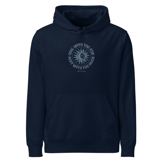 Navy blue organic hoodie with a circular sun/moon design and text 'Rise with the sun, rest with the moon' on a white background