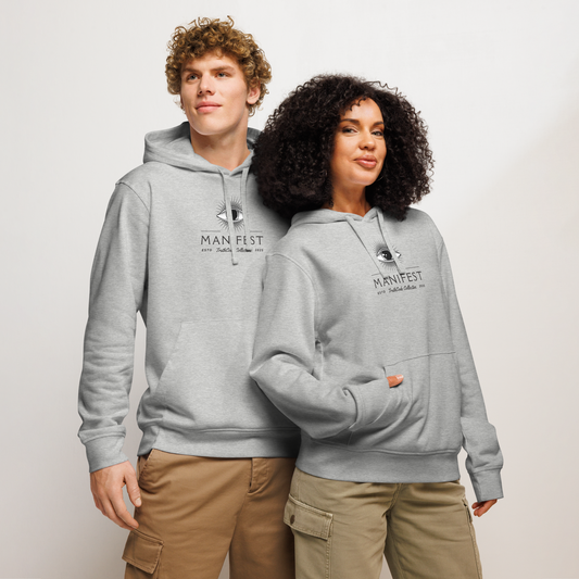 Models wearing gray organic hoodie with text 'Manifest' eye graphic design on a white background
