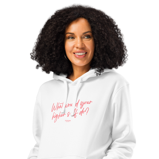 Woman wearing white organic hoodie with pink text 'What would your higher self do?' on a white background