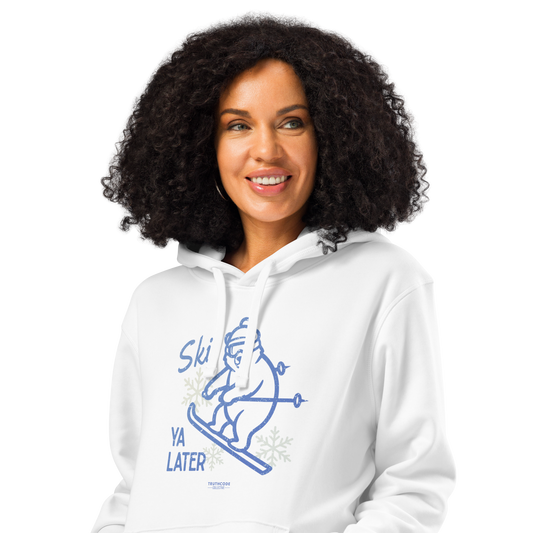 Woman wearing white organic hoodie with a skiing bear graphic and text 'Ski you later' on a white background