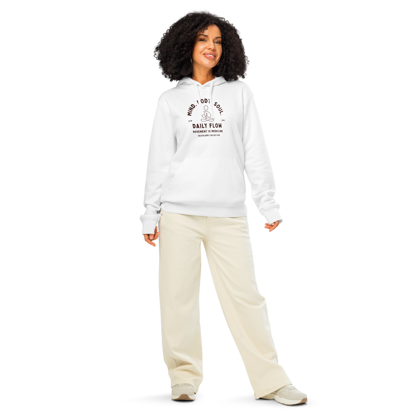 Woman wearing white organic hoodie with 'Daily Flow, movement is medicine' and 'Mind. Body. Soul' text and a line drawing graphic of a person meditating