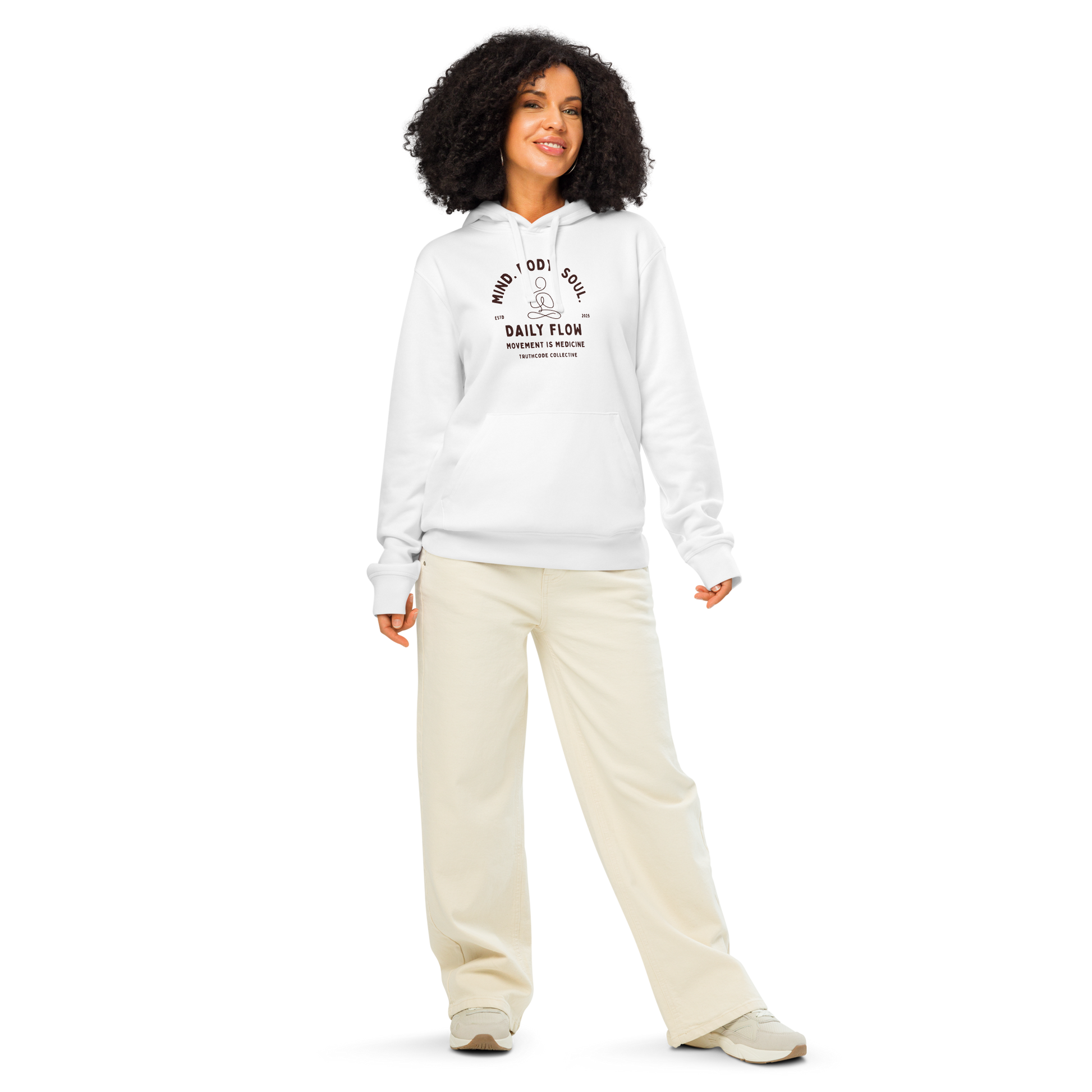 Woman wearing white organic hoodie with 'Daily Flow, movement is medicine' and 'Mind. Body. Soul' text and a line drawing graphic of a person meditating