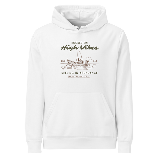 White organic hoodie with text 'Hooked on High Vibes, reeling in abundance' and graphic design of a fishing boat on a white background