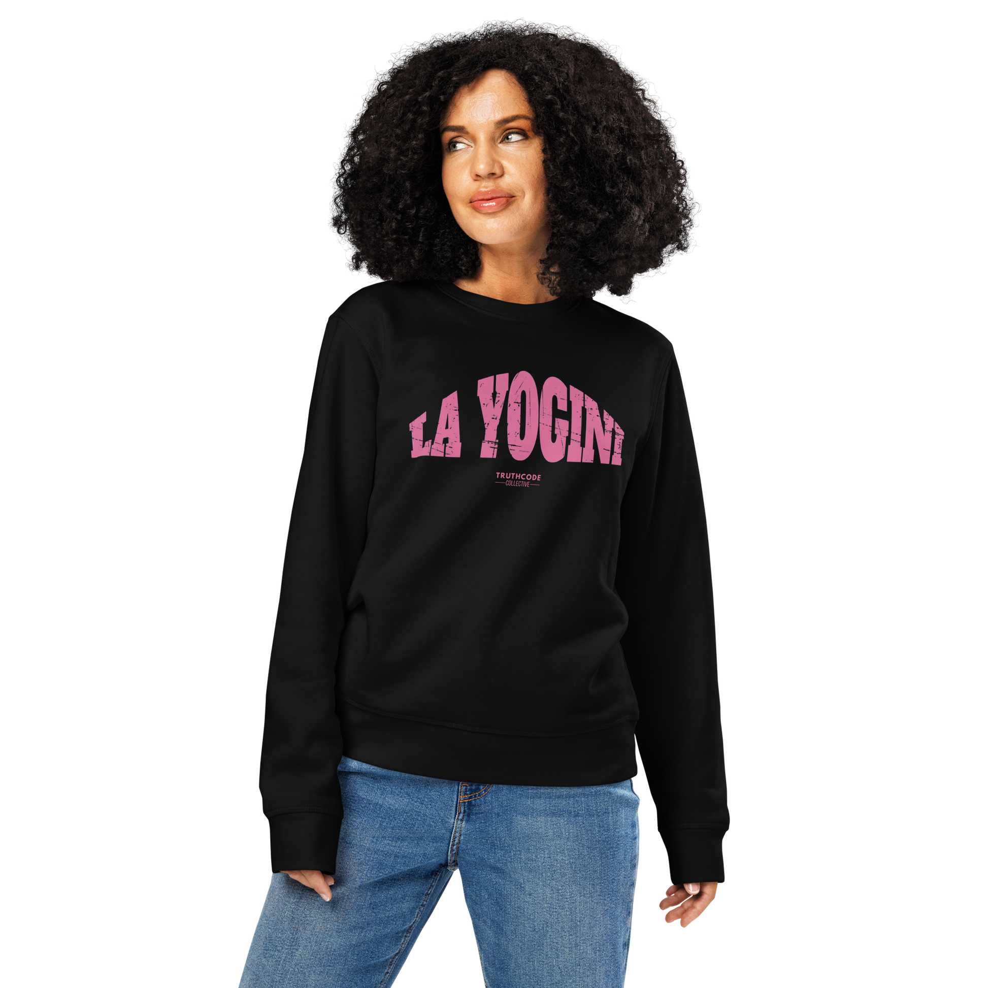 Woman wearing black organic sweatshirt with pink 'LA YOGINI' text on a white background