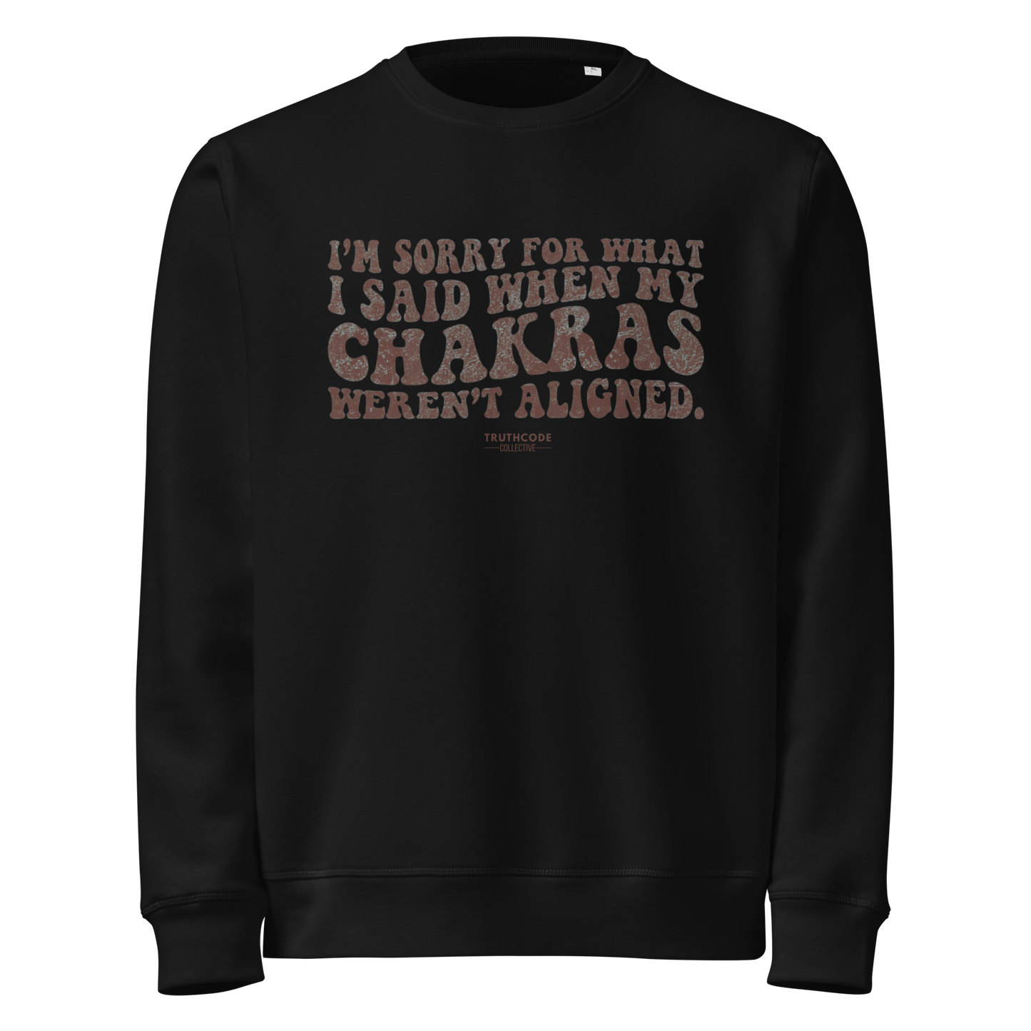 Black organic sweatshirt with humorous text design 'I'm sorry for what I said when my chakras weren't aligned' on a white background
