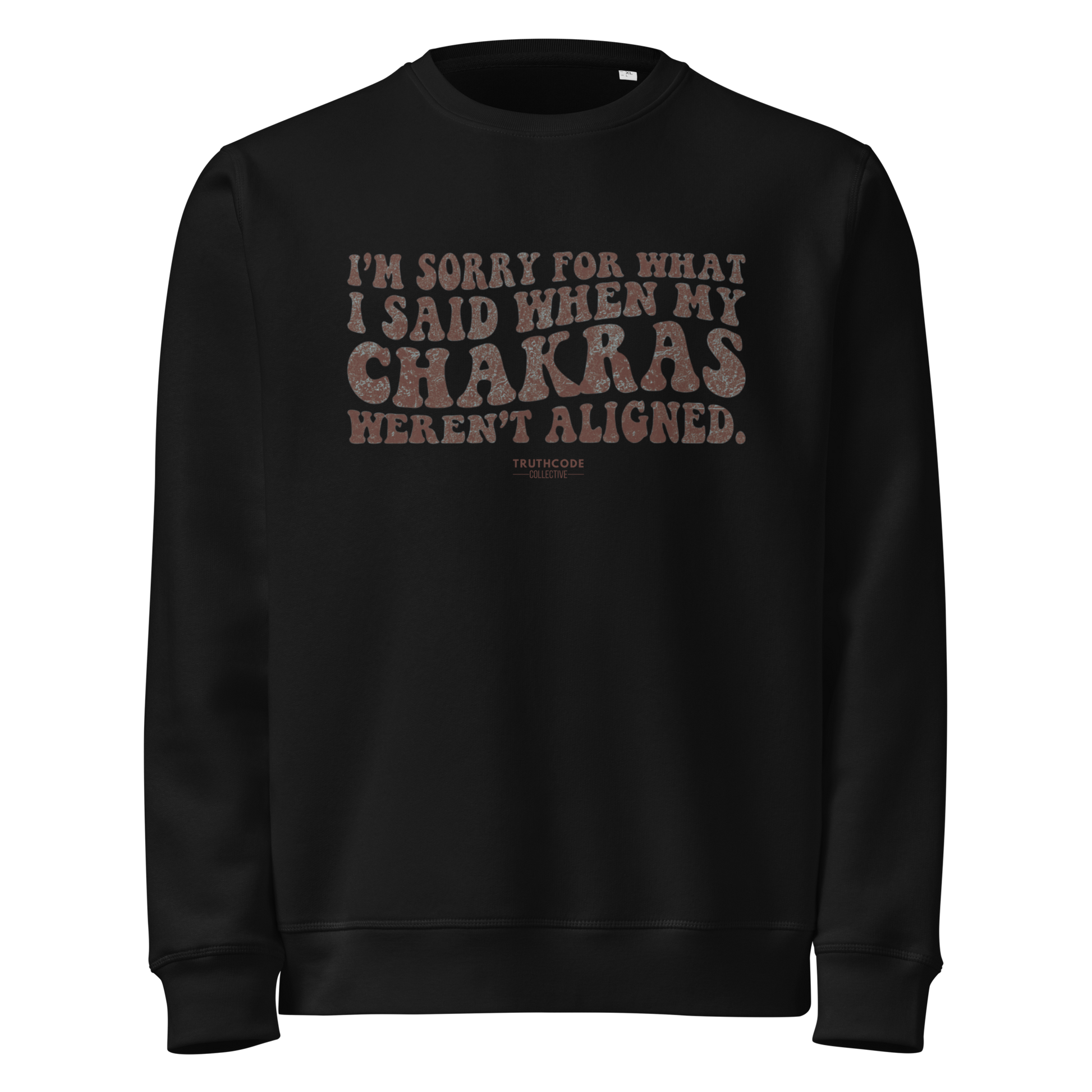 Black organic sweatshirt with humorous text design 'I'm sorry for what I said when my chakras weren't aligned' on a white background