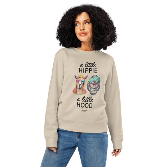 Woman wearing beige organic sweatshirt with a graphic of a llama and monkey wearing headbands and text ' A little hippie, a little hood' on a white background