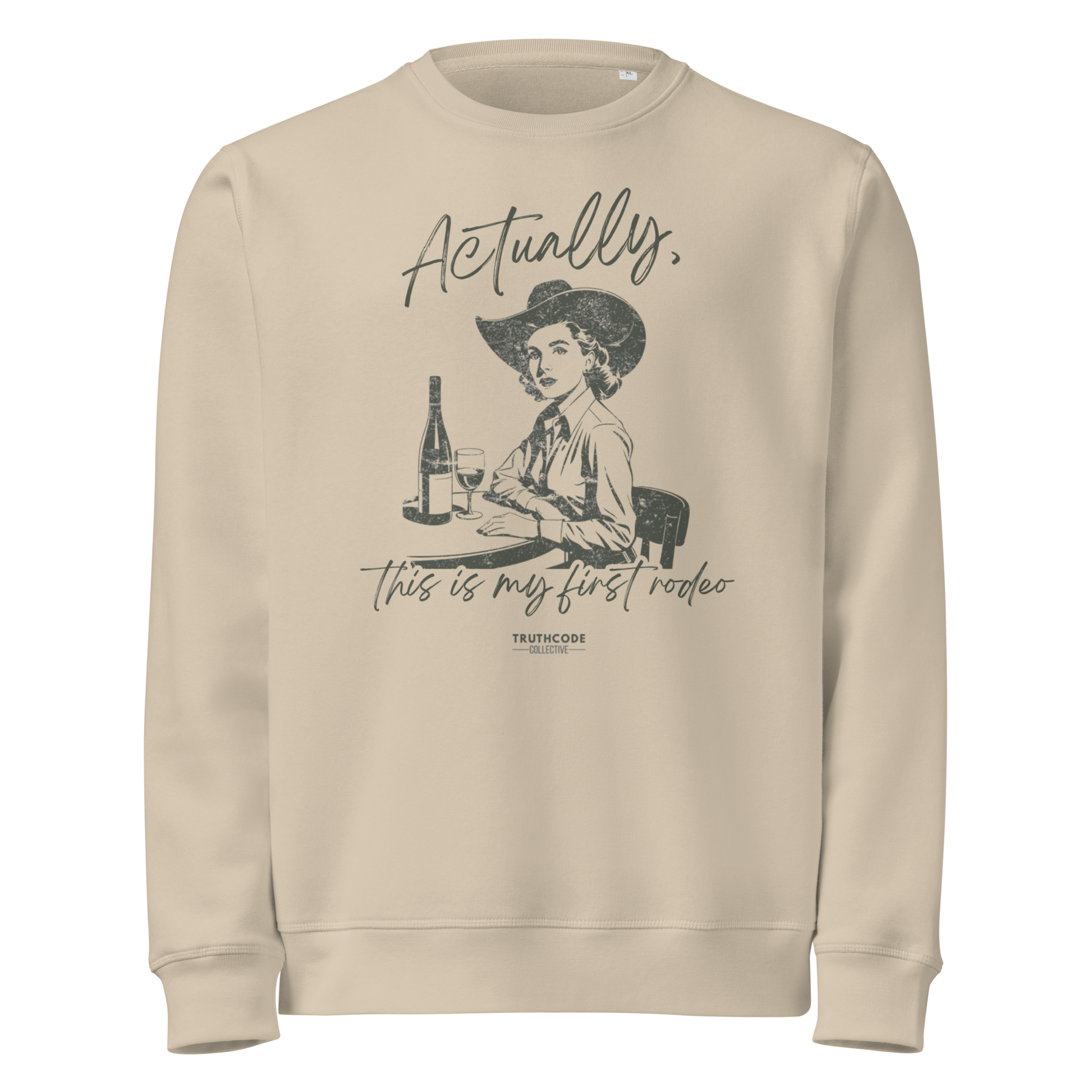 Beige organic sweatshirt with vintage graphic of a woman in a cowboy hat and text 'Actually, this is my first rodeo' on a white background