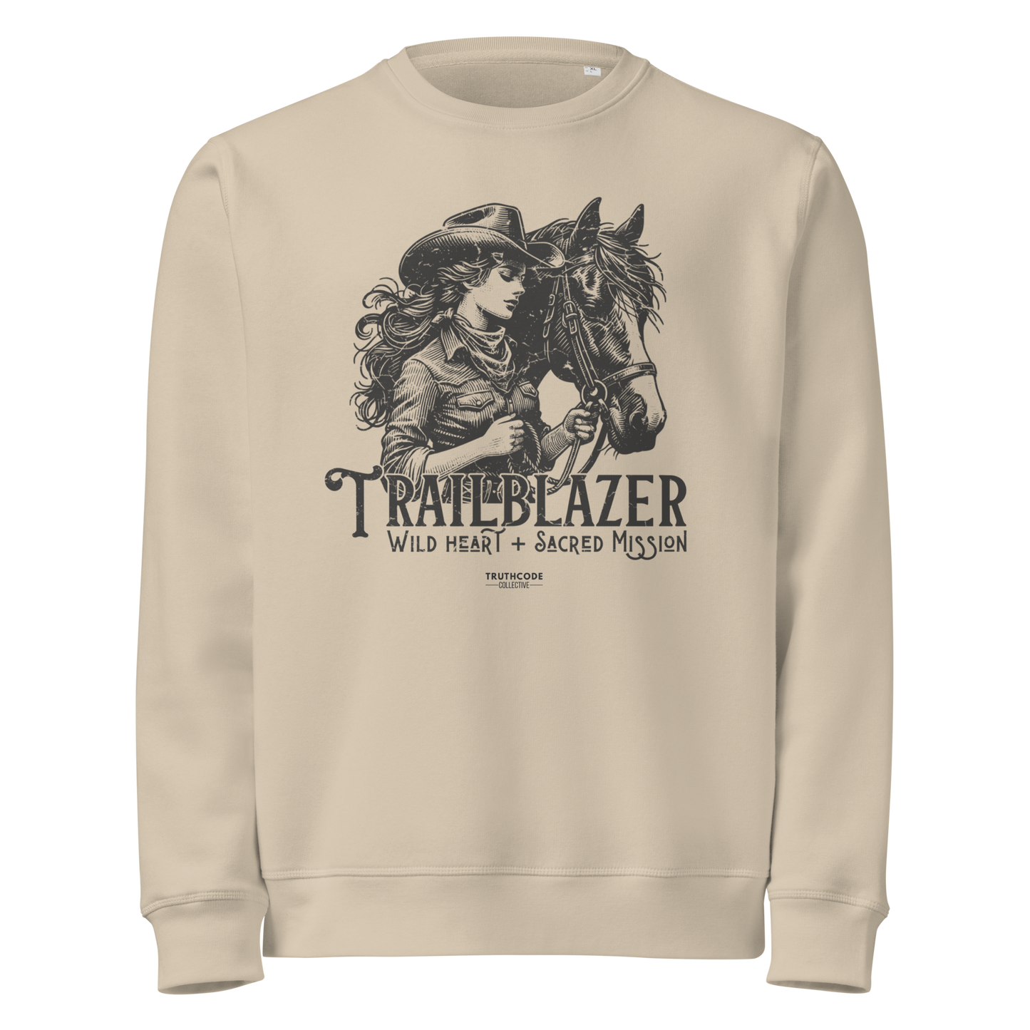 Beige organic sweatshirt with graphic of a woman holding a horse and text 'Trailblazer' and 'Wild heart, sacred mission' on a white background