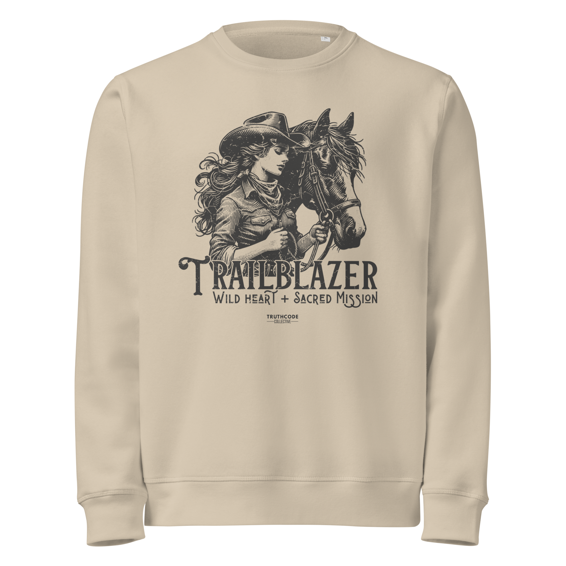 Beige organic sweatshirt with graphic of a woman holding a horse and text 'Trailblazer' and 'Wild heart, sacred mission' on a white background