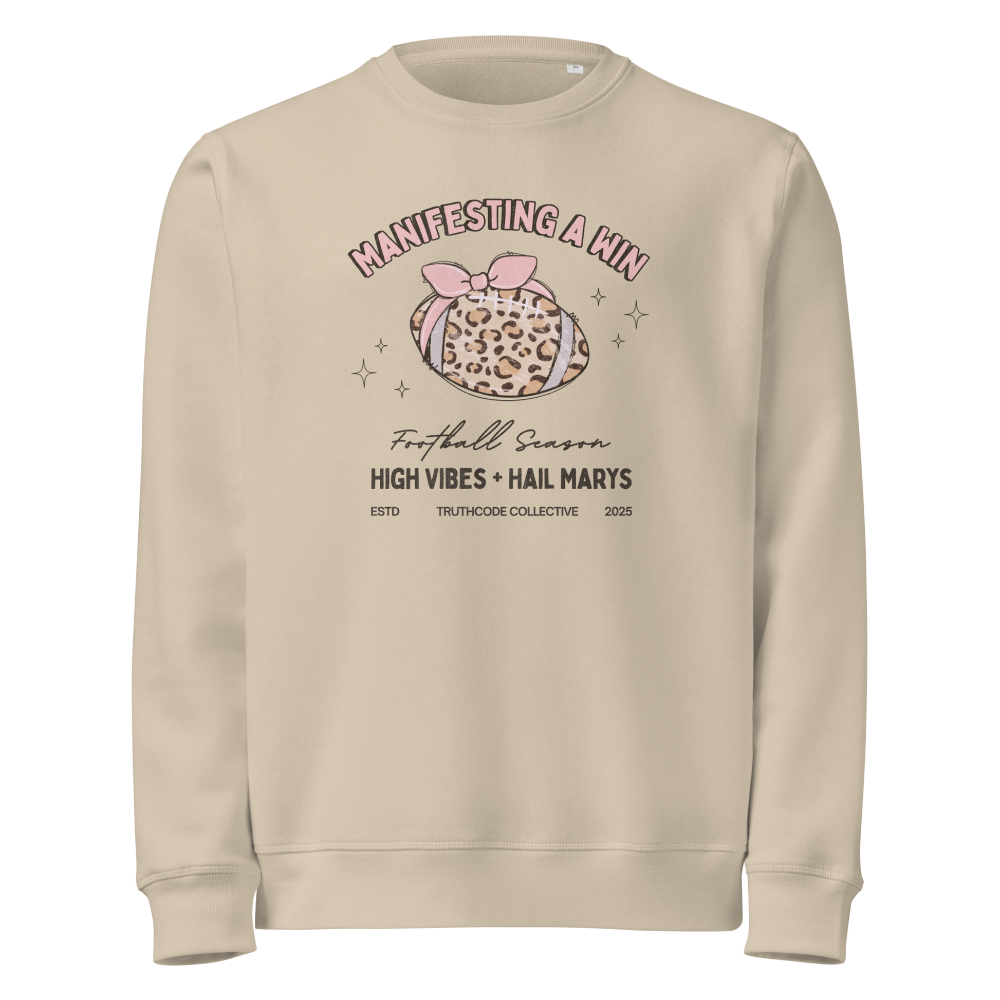 Beige organic sweatshirt with girly football graphic design and text 'Manifesting a win, high vibes + hail marys' on a white background