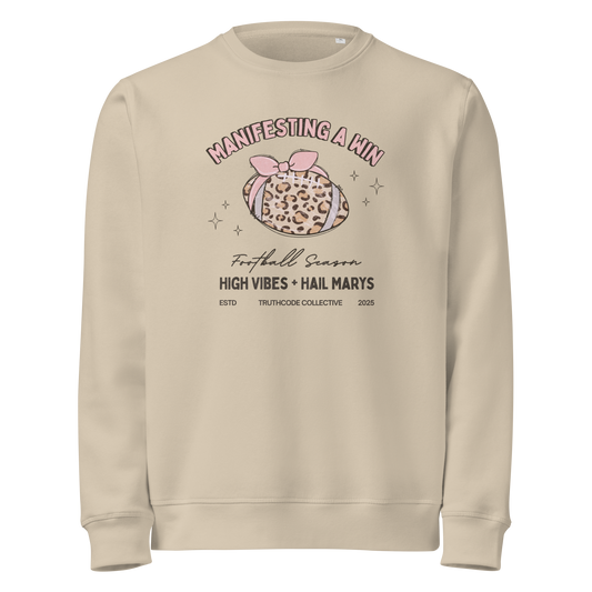 Beige organic sweatshirt with girly football graphic design and text 'Manifesting a win, high vibes + hail marys' on a white background