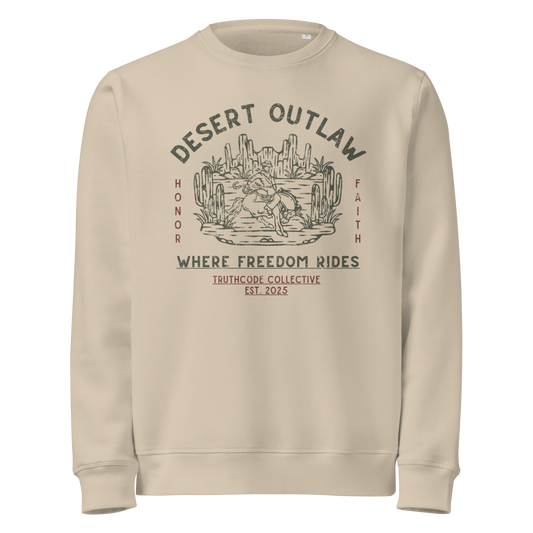 Beige organic sweatshirt with 'Desert Outlaw, where freedom rides' text and graphic design of cowboy riding a broco in the desert, on a white background