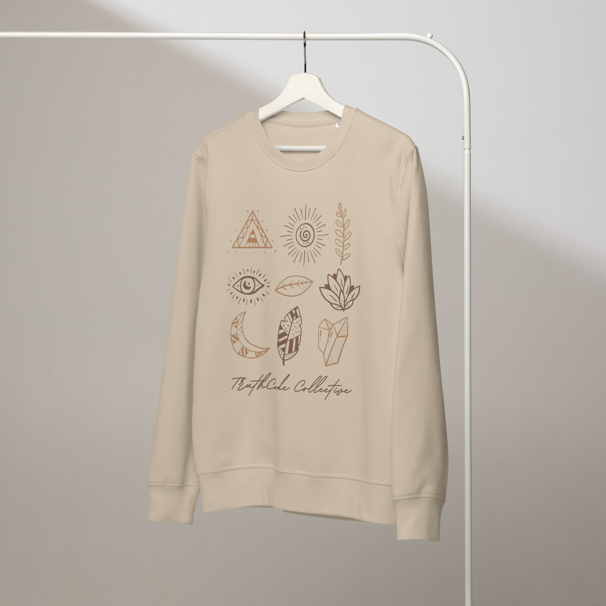 Beige organic sweatshirt with nature-themed graphics and 'TruthCode Collective' text on a white hanger with a plain wall background