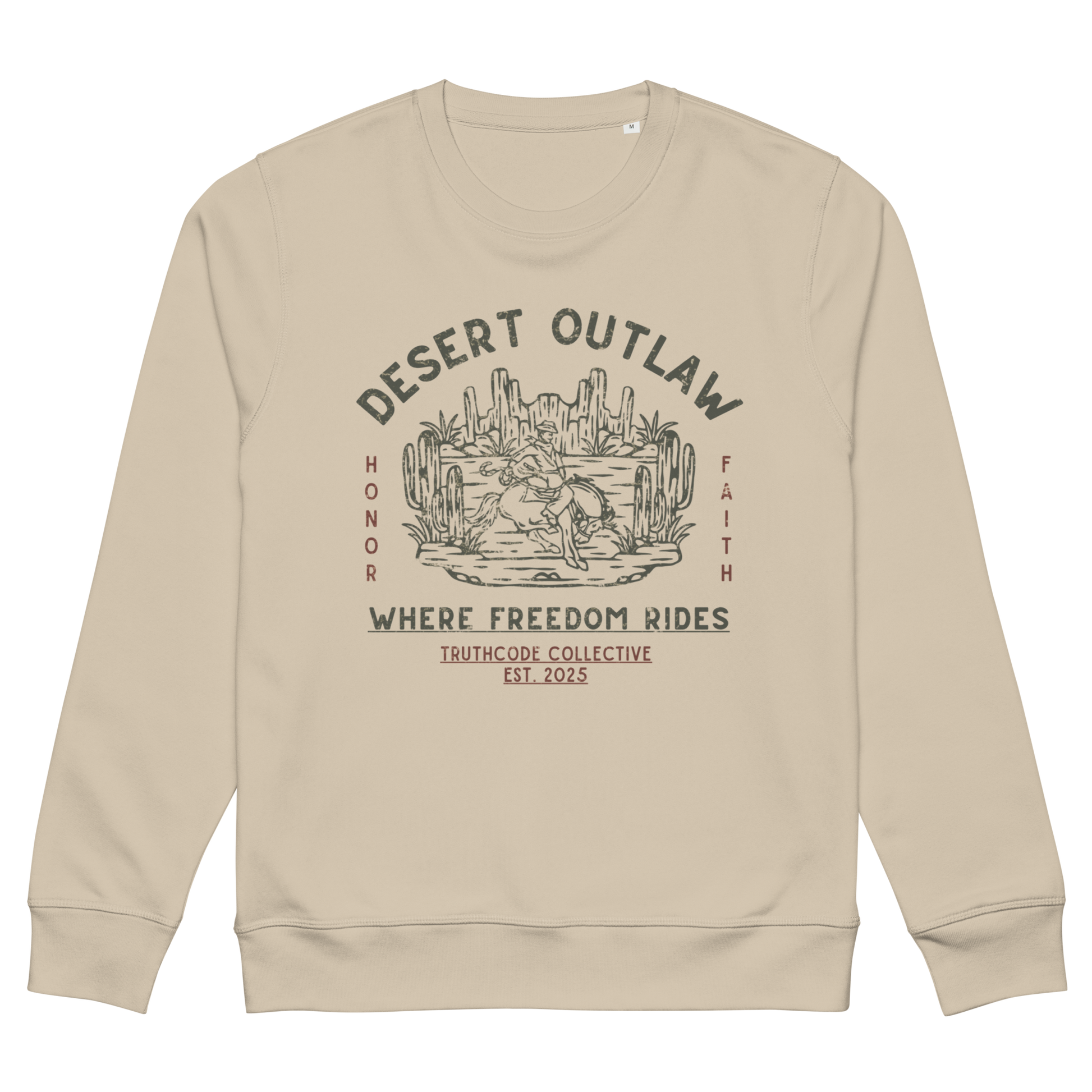 Beige organic sweatshirt with text 'Desert Outlaw, where freedom rides' and scene of cowboy on a bronco in desert graphic design, on a white background